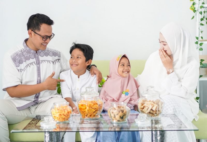Asian Muslim families celebrate Eid together while enjoying a meal