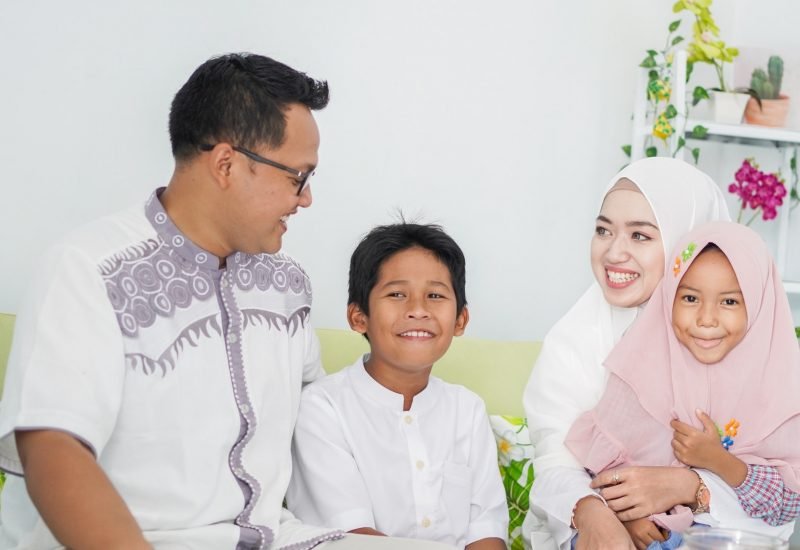 Asian Muslim families celebrate Eid together while enjoying a meal